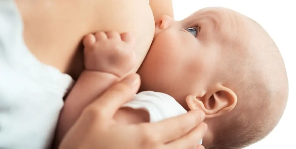 Baby feeds on MOM's breasts