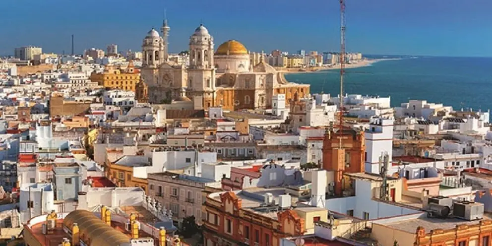 Aerial panorama of the old city rooftops and Cathedral de Santa Cruz in the morning, as seen from tower Tavira in Cadiz.