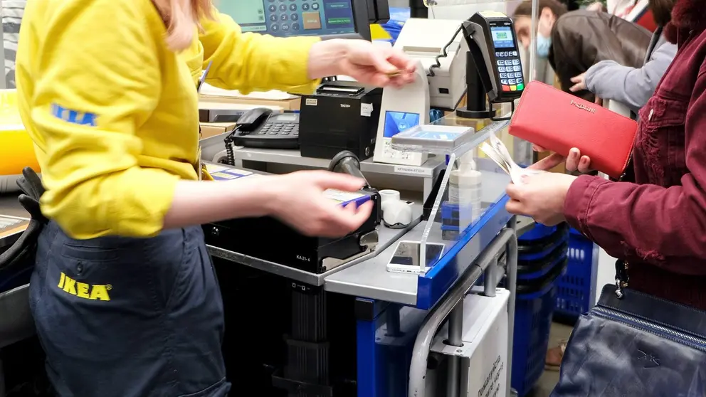 Clienta paga sus compras en la caja de un hipermercado IKEA