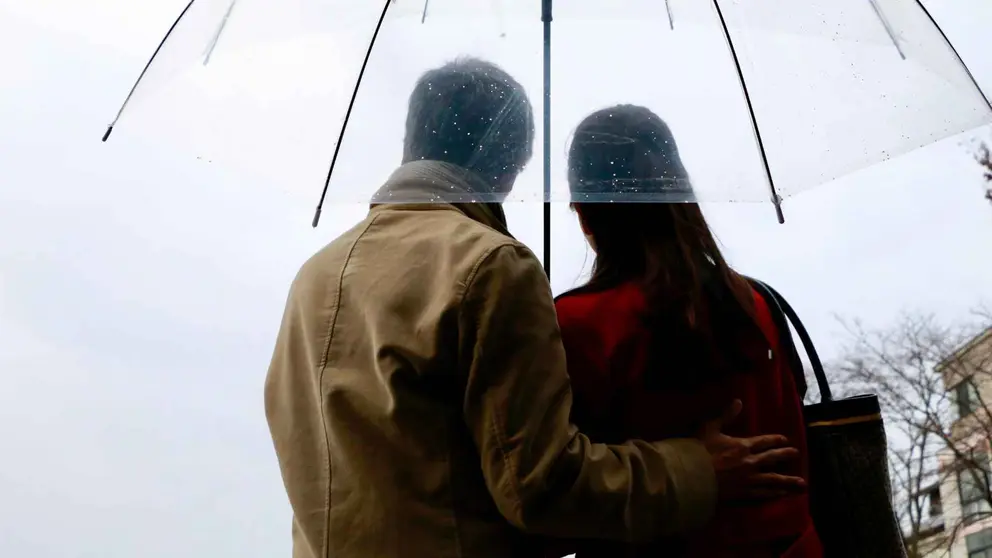 Dos personas con un paraguas bajo la lluvia