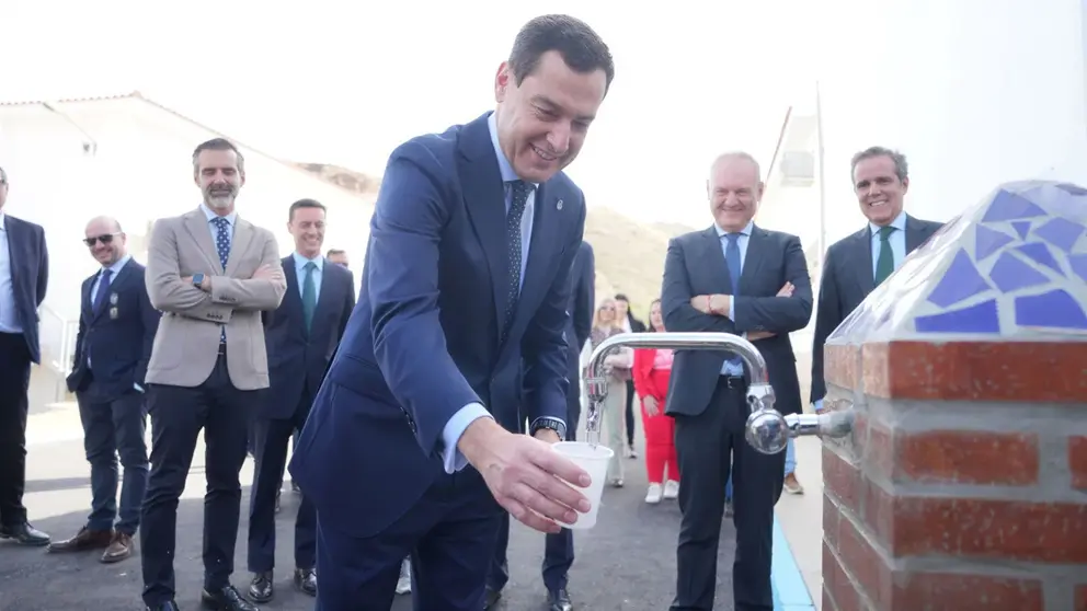 Juanma Moreno llenando un vaso de agua