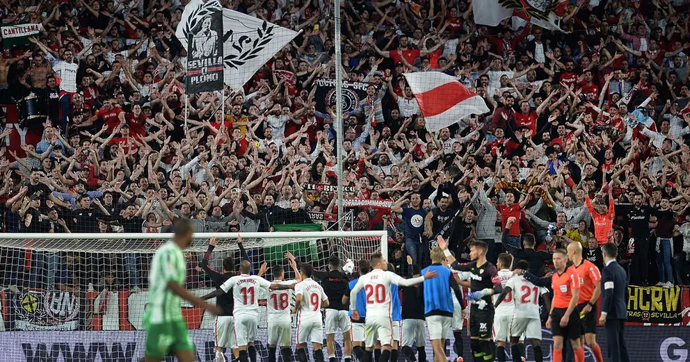 Sevilla's players celebrate with fans at the end of the Spanish league football match between Sevilla FC and Real Betis at the Ramon Sanchez Pizjuan stadium in Sevilla on April 13, 2019. (Photo by CRISTINA QUICLER / AFP)        (Photo credit should read CRISTINA QUICLER/AFP/Getty Images)
