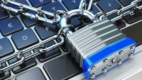 Computer security or safety concept. Laptop keyboard with lock and chain. 3d