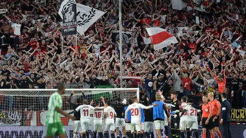 Sevilla's players celebrate with fans at the end of the Spanish league football match between Sevilla FC and Real Betis at the Ramon Sanchez Pizjuan stadium in Sevilla on April 13, 2019. (Photo by CRISTINA QUICLER / AFP)        (Photo credit should read CRISTINA QUICLER/AFP/Getty Images)
