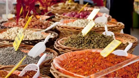 Spices on wooden basket in a street market