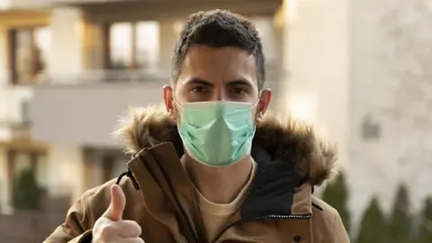 Man wearing hygienic mask to prevent the virus PM2.5 and Coronavirus. People in masks The outbreak of Novel Corona virus (2019-nCoV) in Wuhan China. air pollution, Environmental awareness concept.