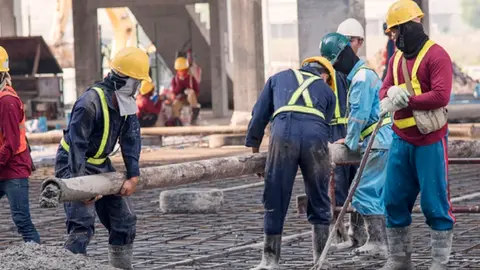 Construction worker Concrete pouring during commercial concreting floors of building in construction site and Civil Engineer