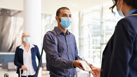 Passenger showing e-ticket at airport during covid pandemic