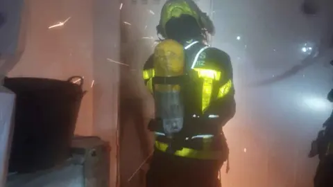 Bomberos actuando en el incendio de una casa en Torremelgarejo