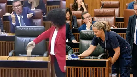 Una limpiadora recoge la arena tirada por Maribel Mora sobre el esca&ntilde;o de Juanma Moreno