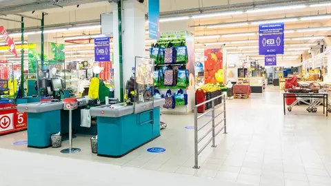 Mostradores de caja con escudos protectores transparentes en las instalaciones del hipermercado Carrefour