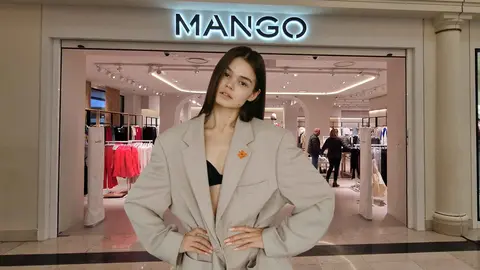 Una mujer a la moda frente a una tienda de Mango