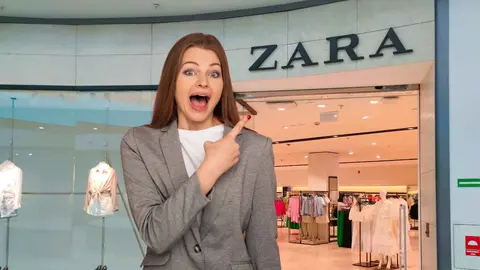 Una mujer a la moda frente a una tienda de Zara