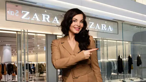 Una mujer a la moda frente a una tienda de Zara