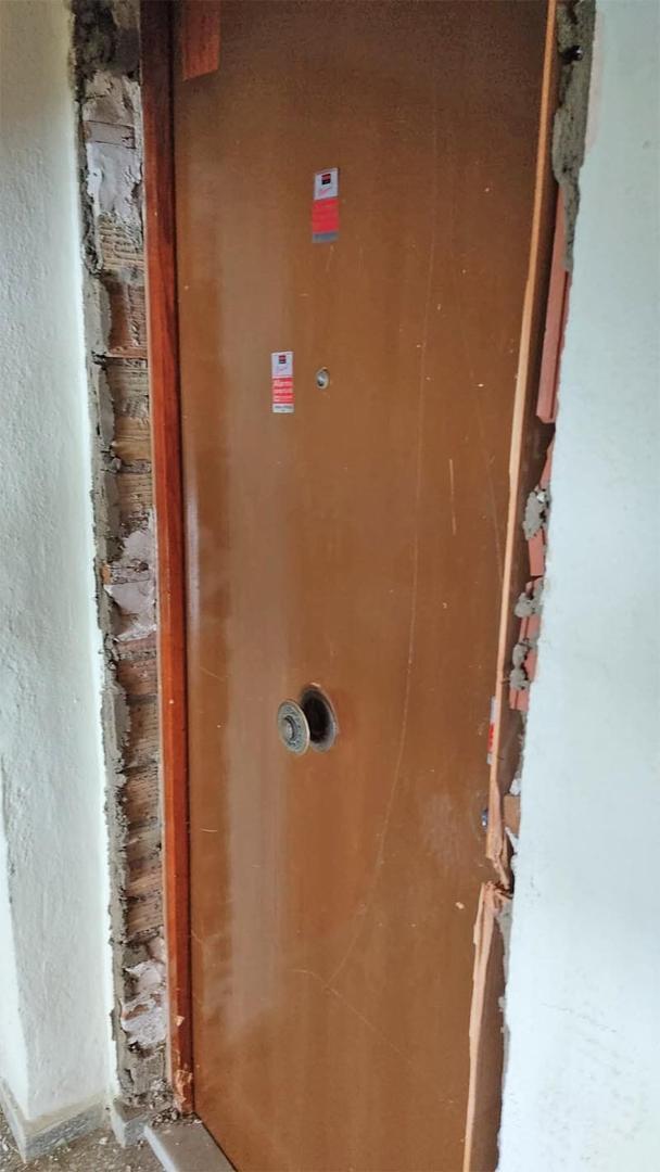 Estado de puerta tras ocupación de pisos en Jerez con butrón 
