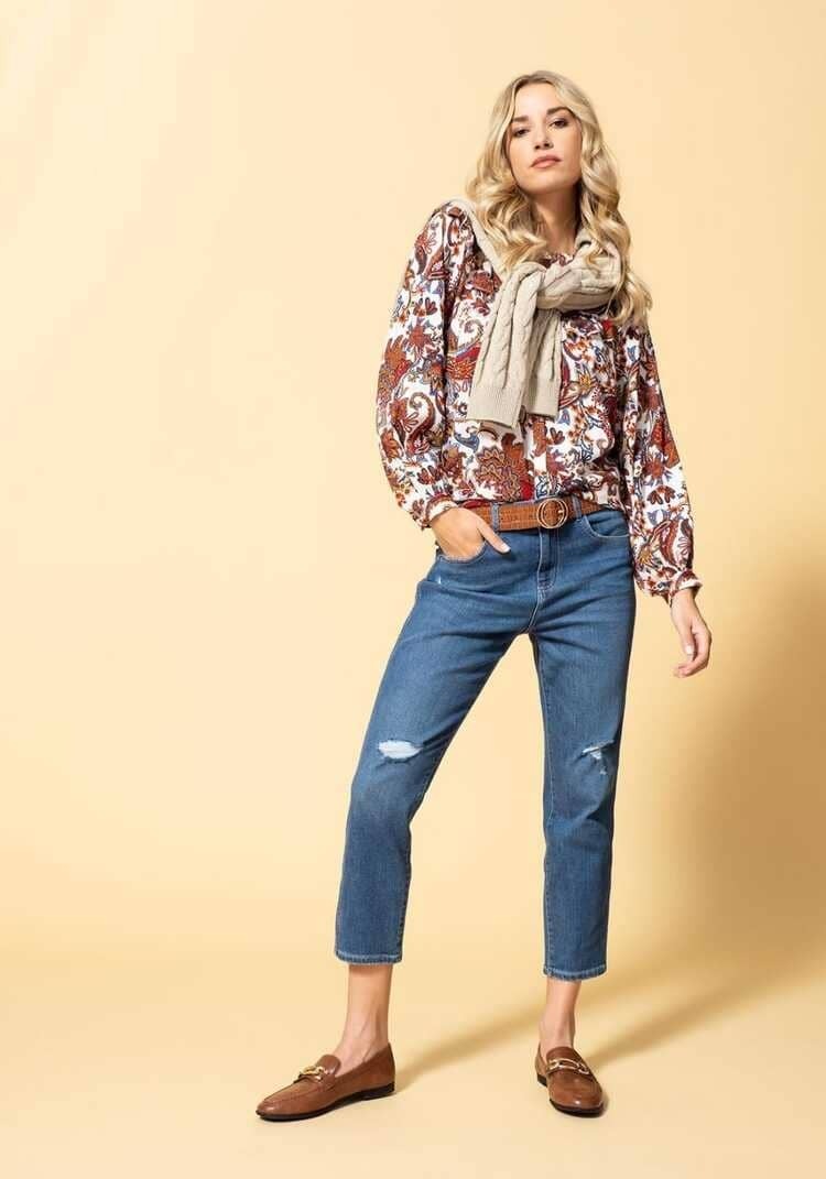 Look de pantalón vaquero, jersey y blusa con volante