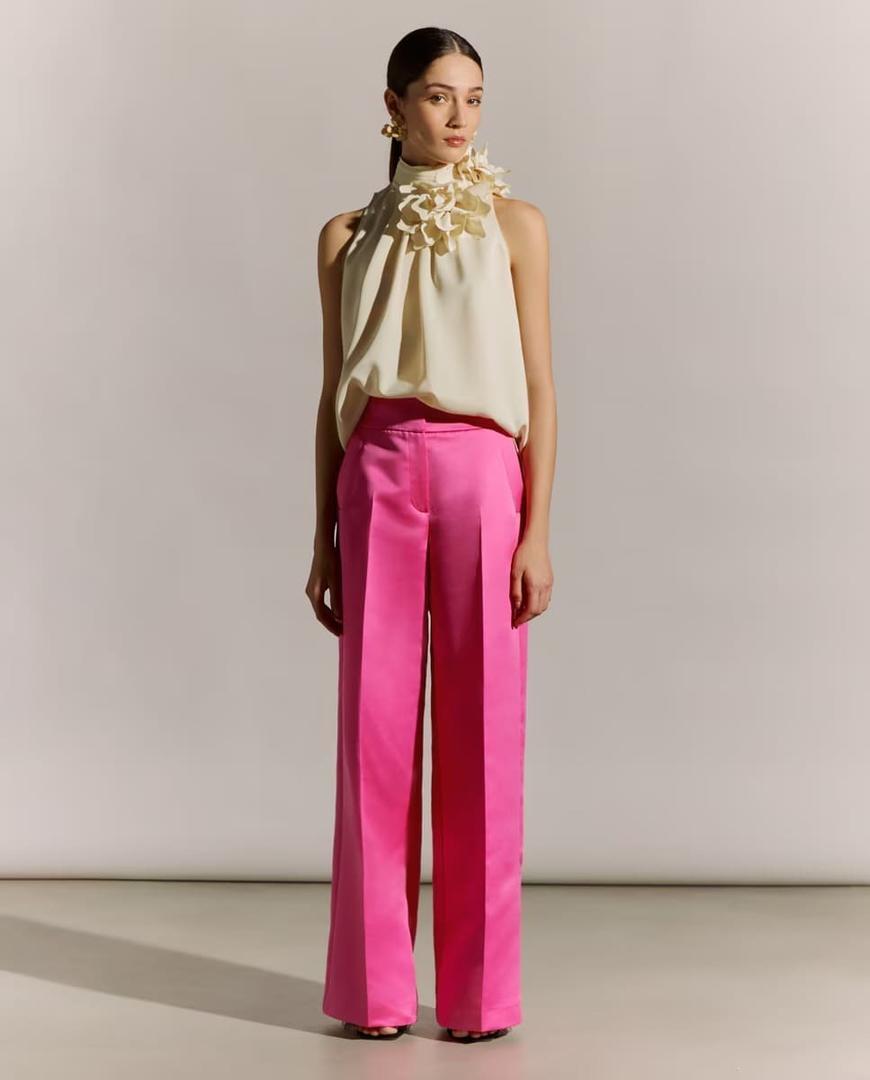 El conjunto de top sin mangas y cuello halter blanco y pantalón ancho de satén fucsia de El Corte Inglés