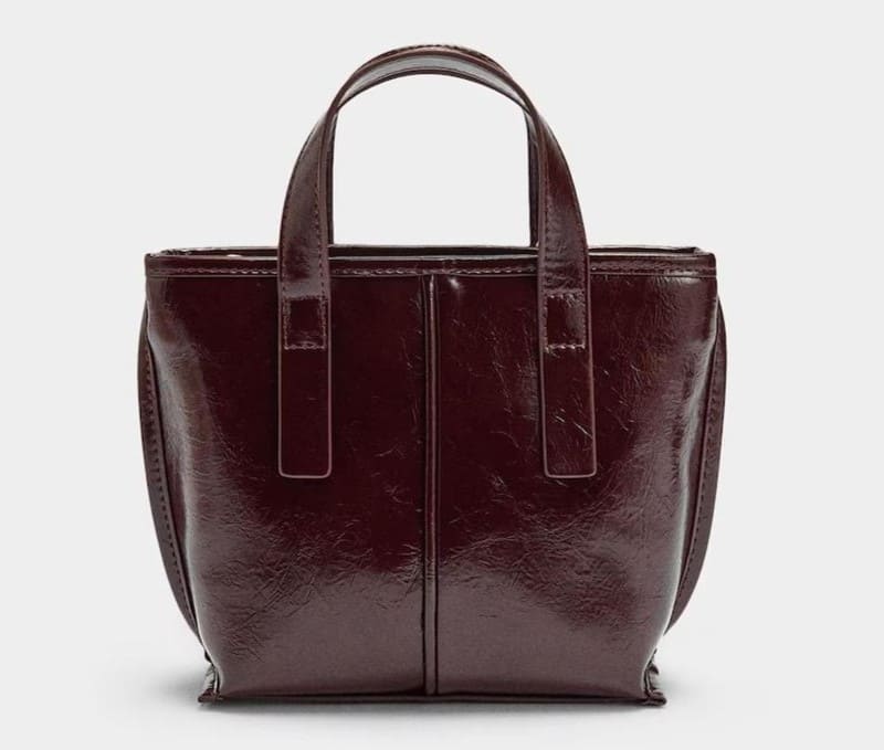 Bolso de mano estilo tote convertible a bandolera con cierre de cremallera en liso